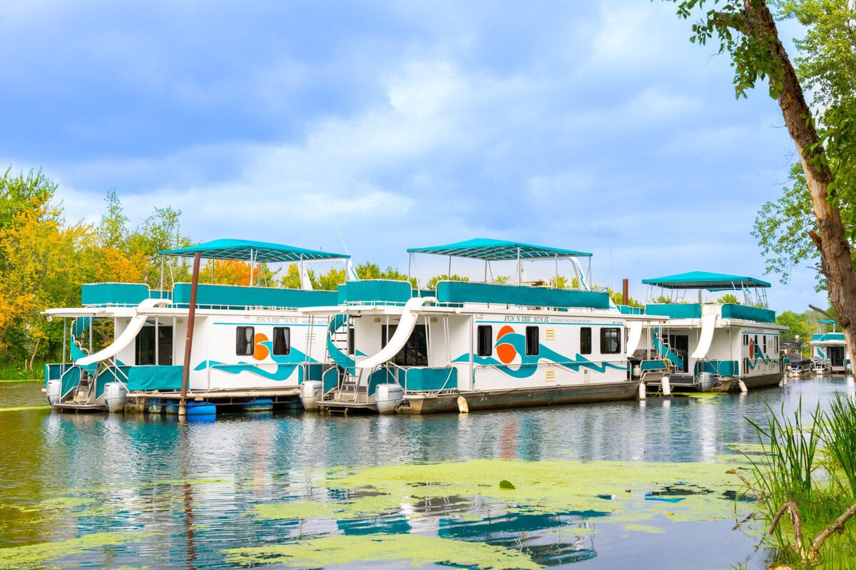 Boats on the scenic river in Buffalo County Wisconsin during daytime with lush greenery.